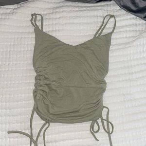 Cropped tank top. Green. Cut-Out sides. Adjustable straps and strings. Size S